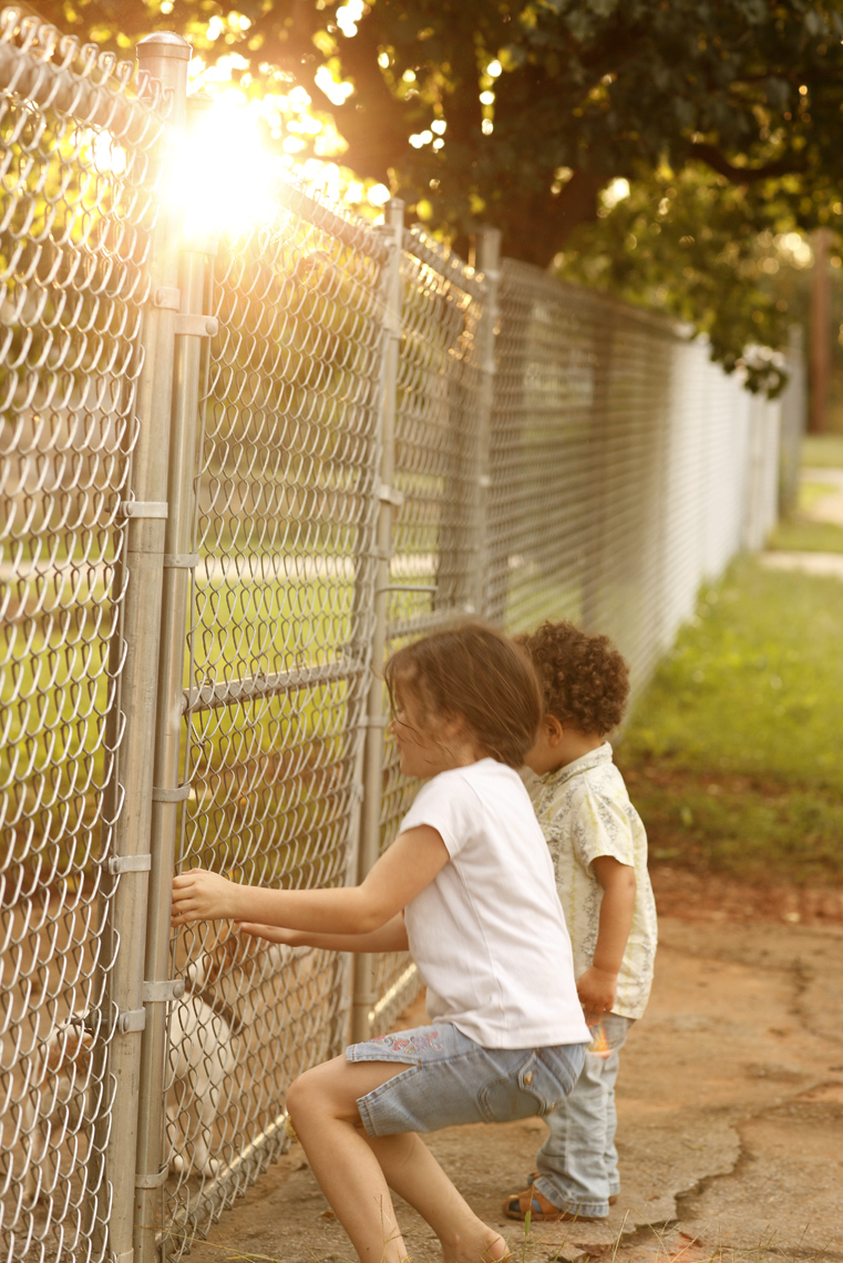 Mali Azima lifestyle kids chainlink fence.jpg